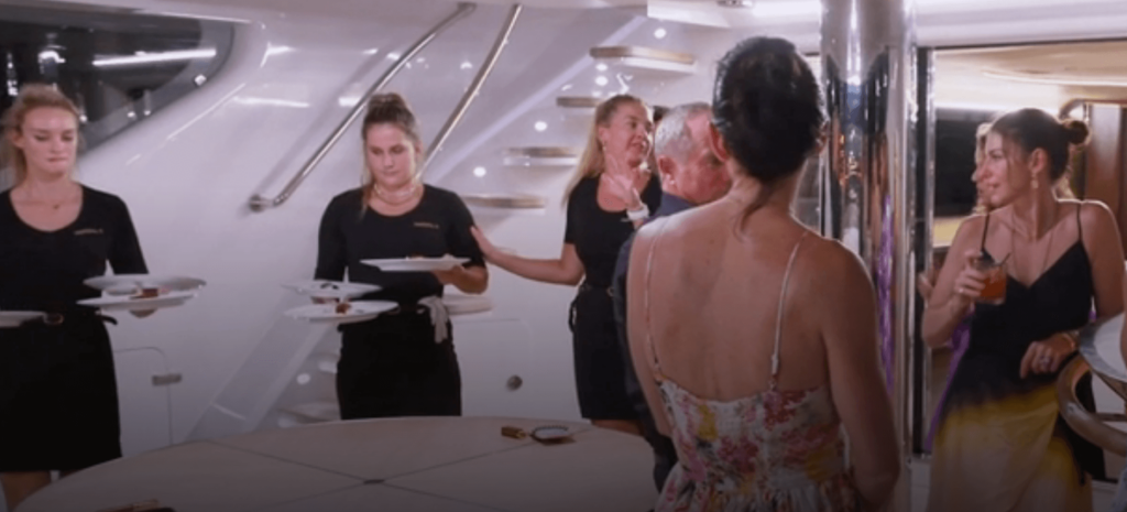 The Below Deck Sailing Yacht crew serving dinner